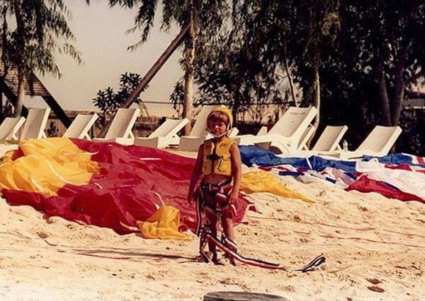 lee abbott when he was a child on a beach with a parasail>