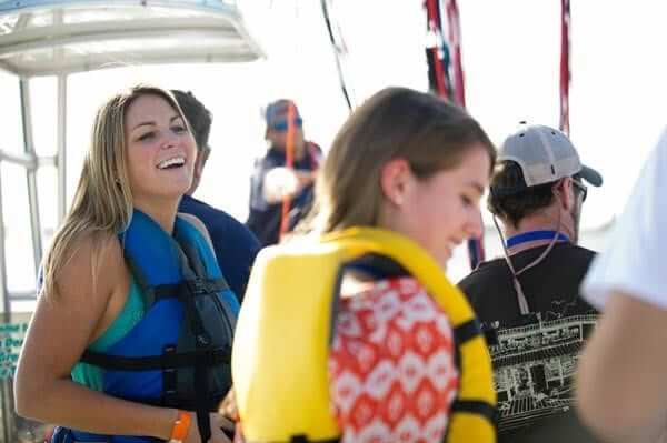 two girls wearing life jackets>